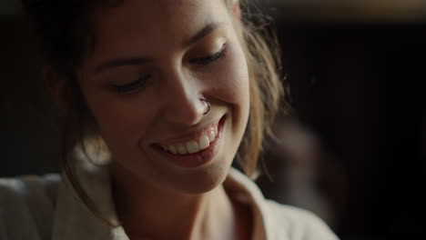 dreamy girl smiling indoors. positive woman making something in workshop