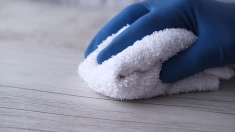 cleaning a wooden surface with a white cloth