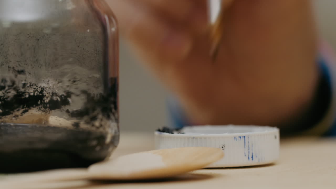 Artist painting with dark paint