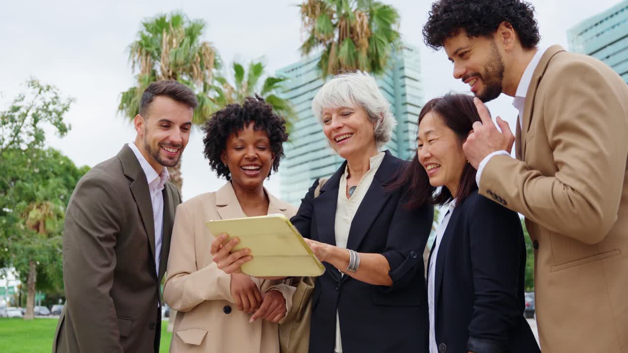 Business team collaborating outdoors using a tablet