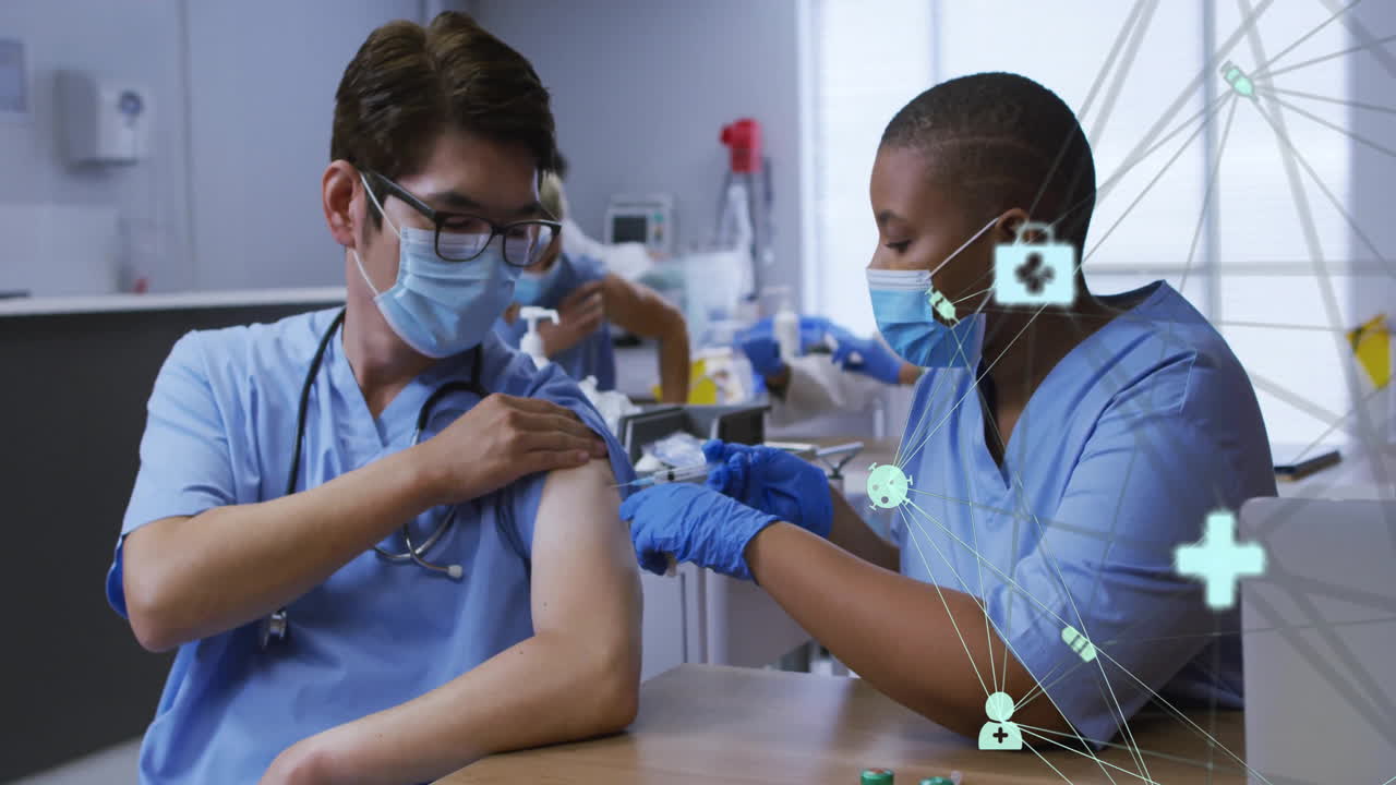 Healthcare network and medical icons animation over healthcare professionals administering vaccine