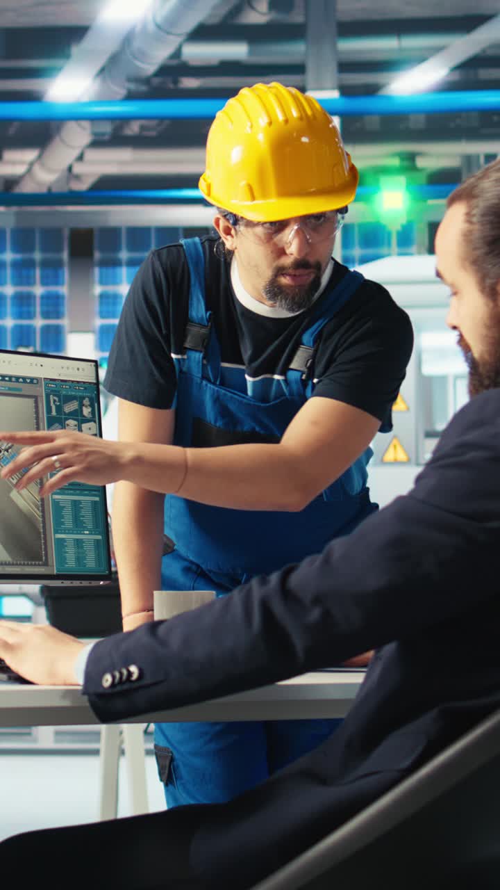 Vertical Video Specialist Showing Staff Member How To Optimize Solar Panel Energy Supply