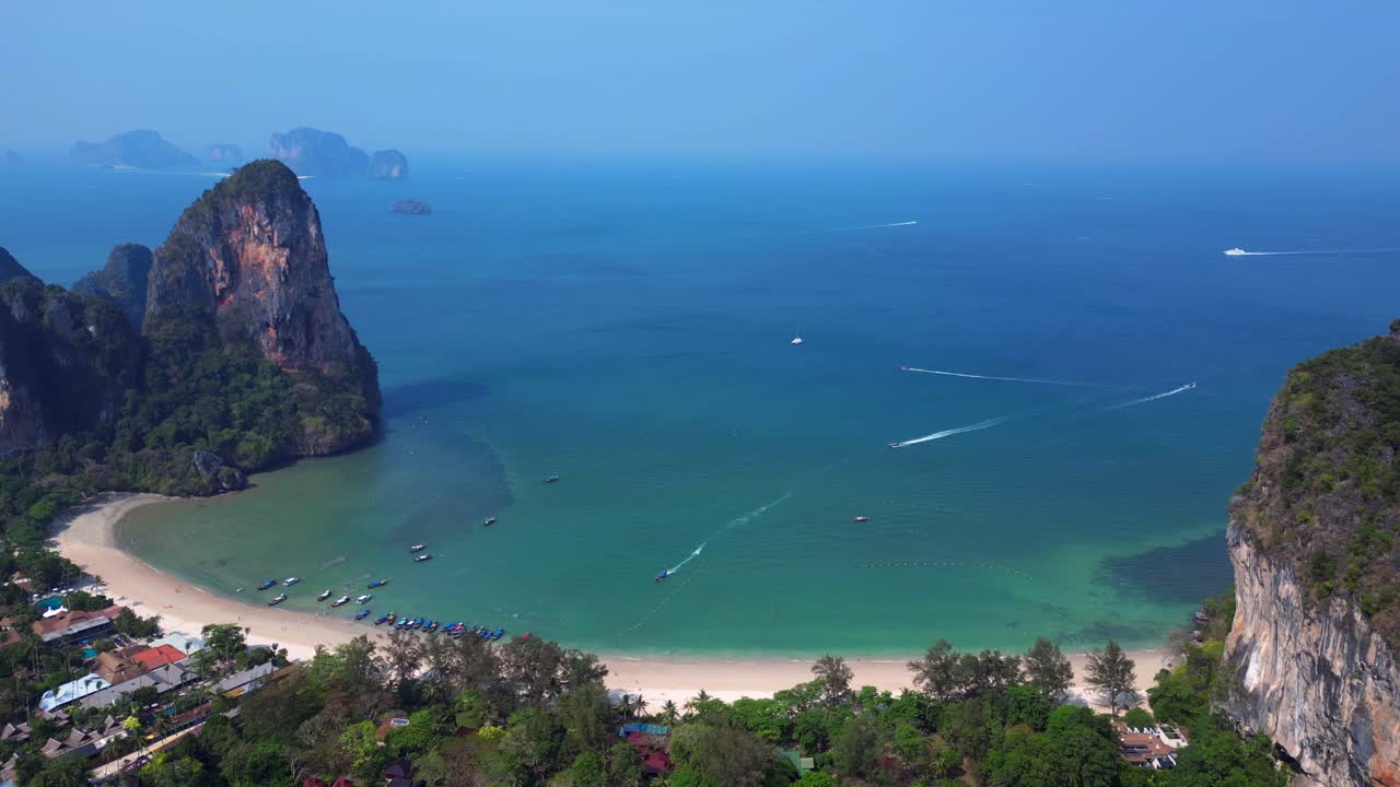 Railay Beach and Phra Nang Cave Beach in Krabi, Thailand, featuring limestone cliffs, turquoise water, and longtail boats. Nice aerial view flight drone shot footage from above