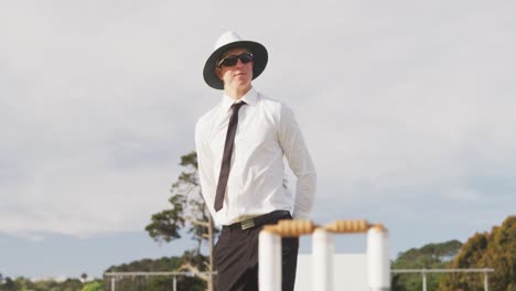 cricket umpire making signs standing on a cricket pitch