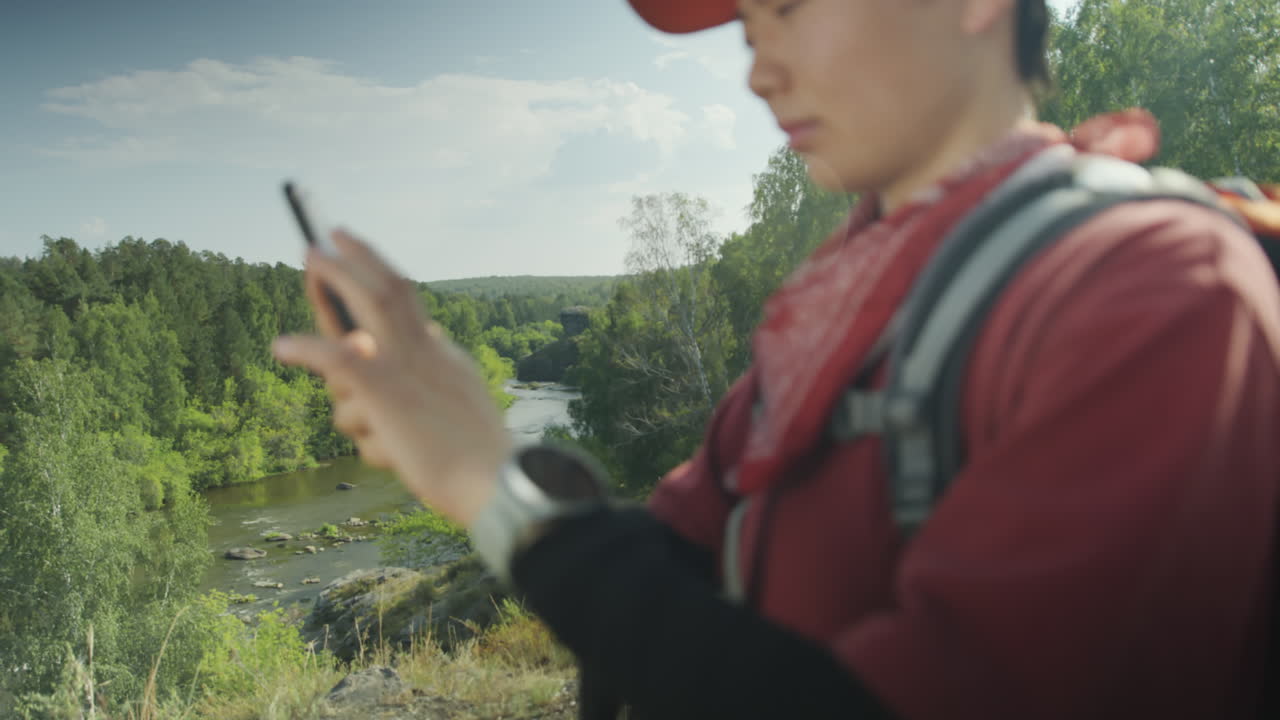 Female Hiker Using Phone and Smartwatch