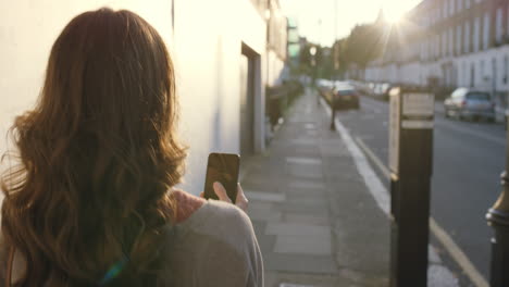 beautiful woman using smart phone technology app walking through city