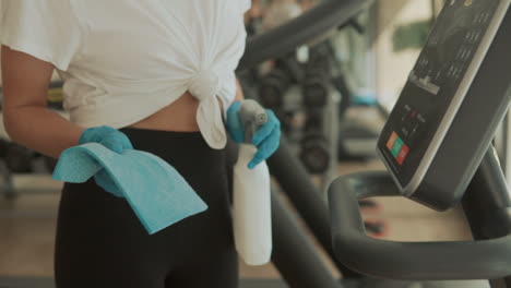 disinfecting and cleaning exercise machines in the gym 2