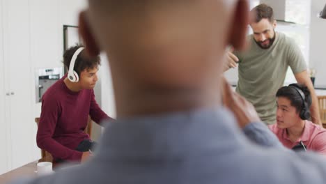 Happy-diverse-male-friends-talking-and-recording-in-living-room