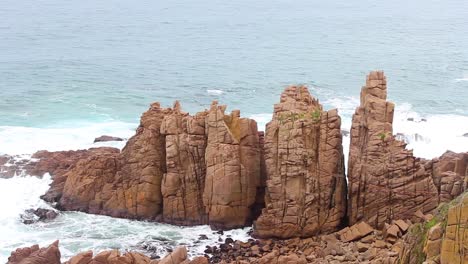 a shot of the wild ocean of cape woolamai victoria australia with the rugged cliffs of the pinnacles