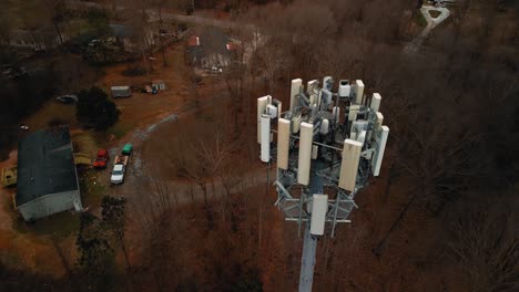 aerial shot rotating around cell phone tower in forest. 4k drone