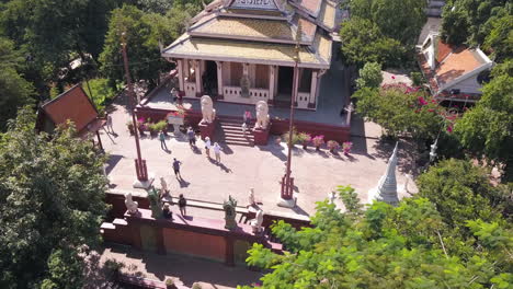 4k drone footage people at wat phnom temple, cambodia