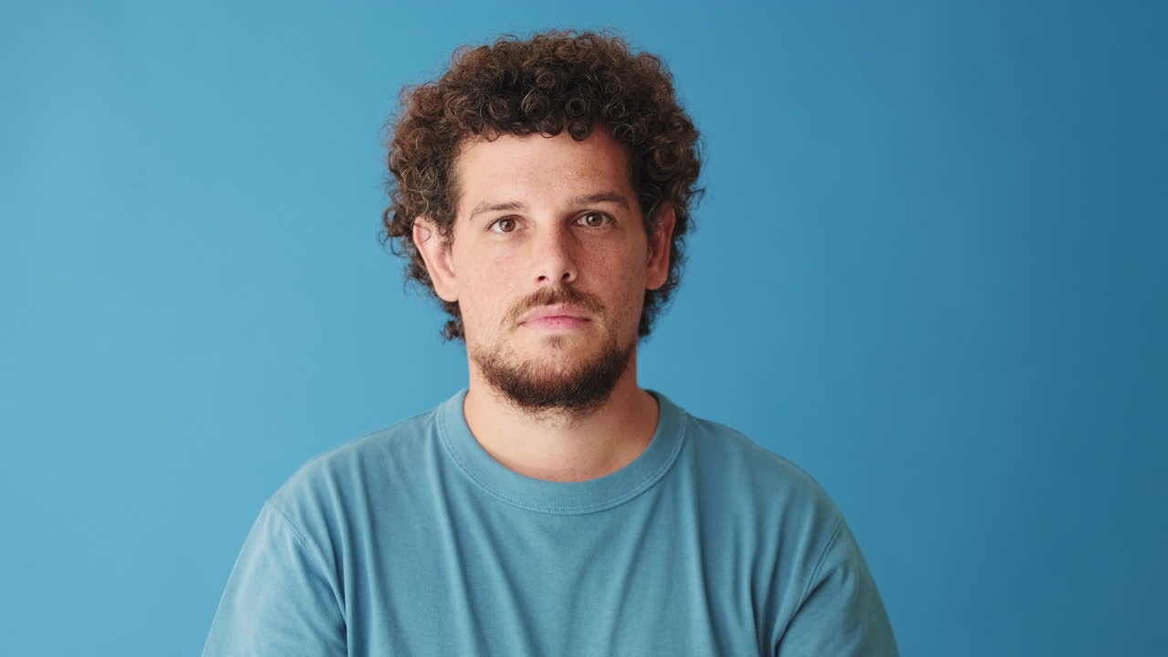Man giving thumbs up on blue background
