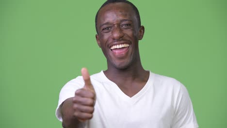 young happy african man smiling while giving thumbs up