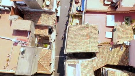 Vertical-shot-flying-across-a-long-walkway-during-a-sunny-day