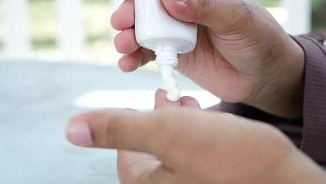 man applying cream to his finger