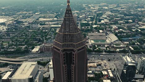 hyperlapse drone shot of bank of america in atlanta city during misty day - descending tracking movement in time lapse - traffic on highway