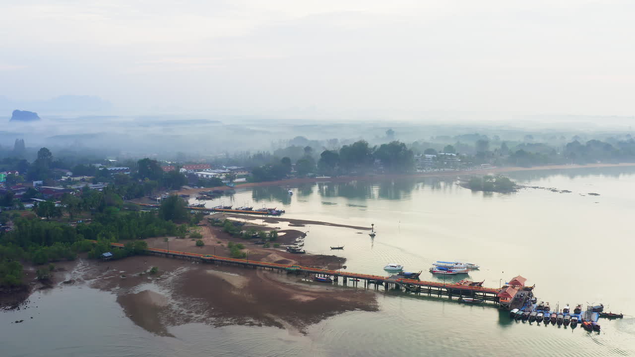 niebla sobre el muelle flotante y el puerto del océano en tailandia durante la marea baja