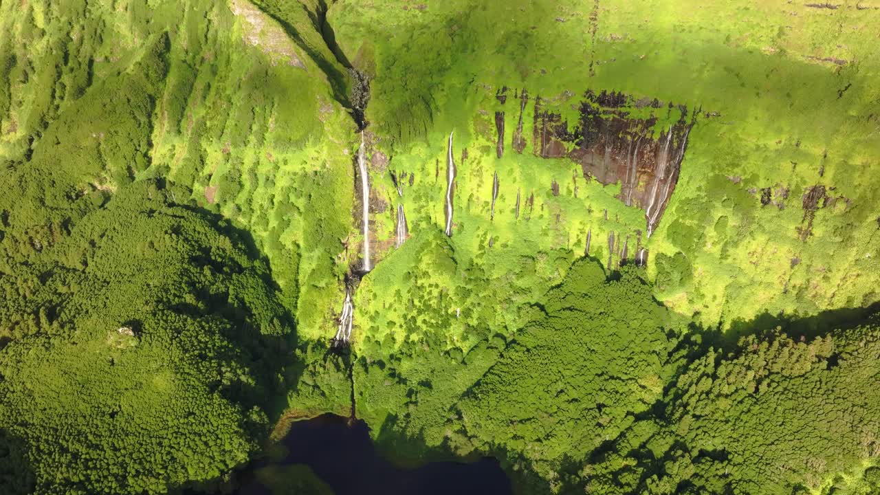 Waterfall Po&ccedil;o Ribeira do Ferreiro at Flores island in bright sunlight, aerial