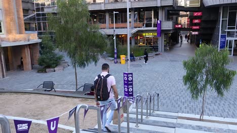 man descends stairs outside a building