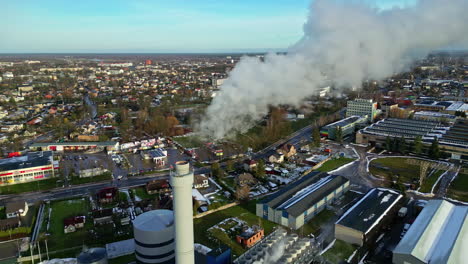 industrial area with smokestacks, buildings, and vibrant activity, clear skies