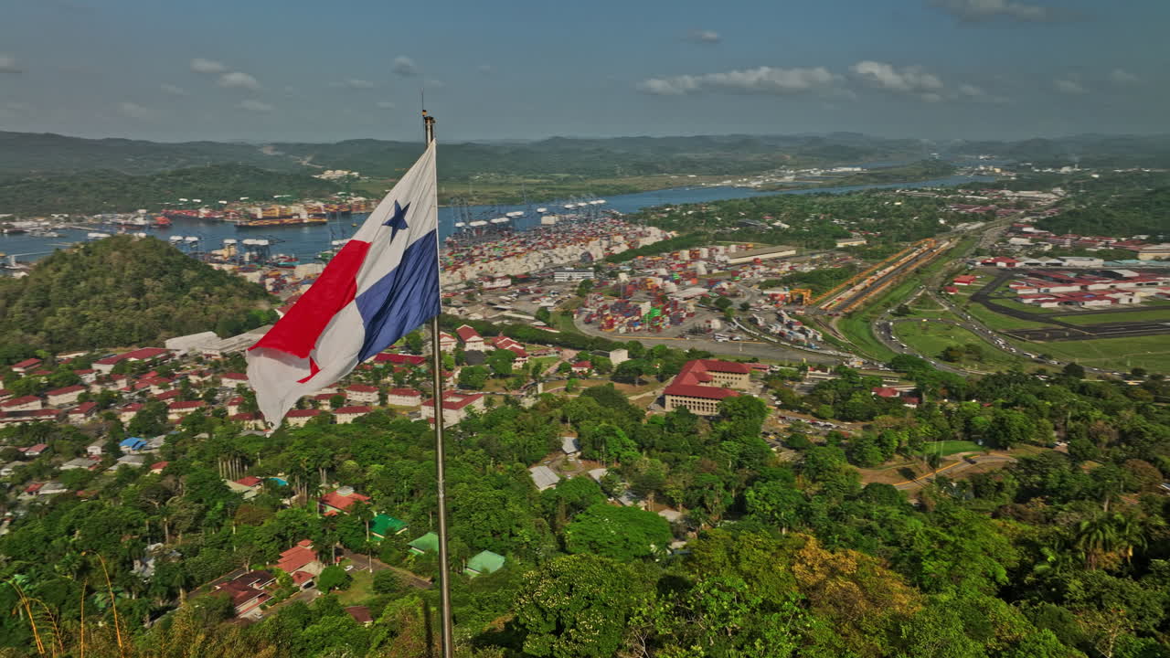 Panama City Aerial v65 panoramic view fly around national flag on ancon hill capturing port of balboa shipyard canal, historic district and downtown cityscape - Shot with Mavic 3 Cine - March 2022