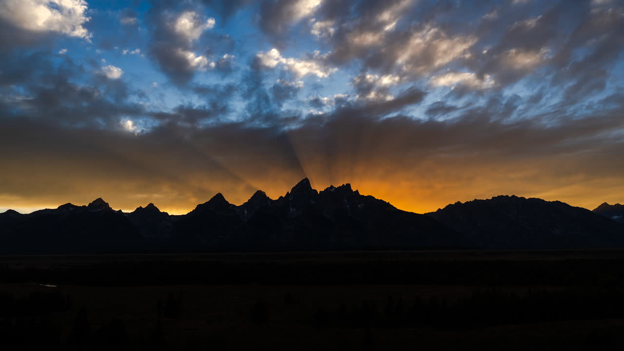 Dramatic Sunset Over Silhouetted Mountains