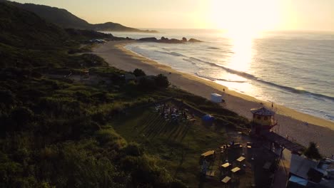 yoga training for group of people on the beach during sunset, aerial view
