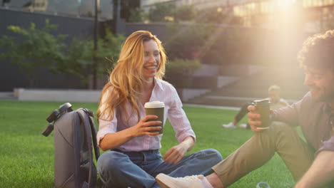 happy couple enjoying picnic in urban park. closeup woman relaxing closing eyes