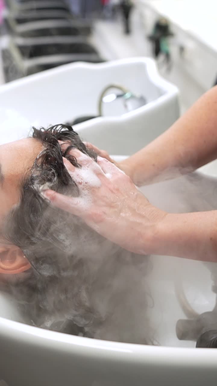 Donna che si lava i capelli in un salone