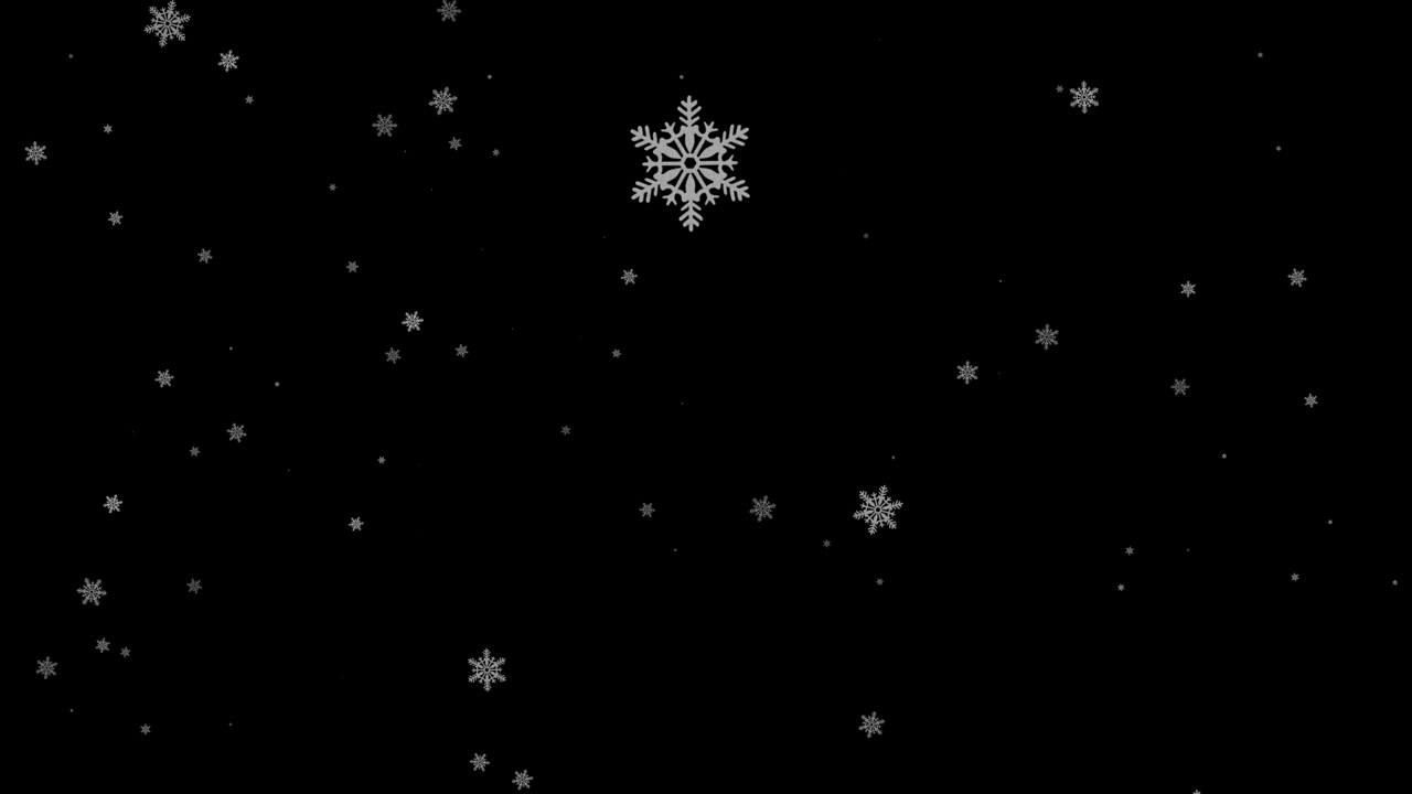 Fallende snøflak på svart bakgrunn