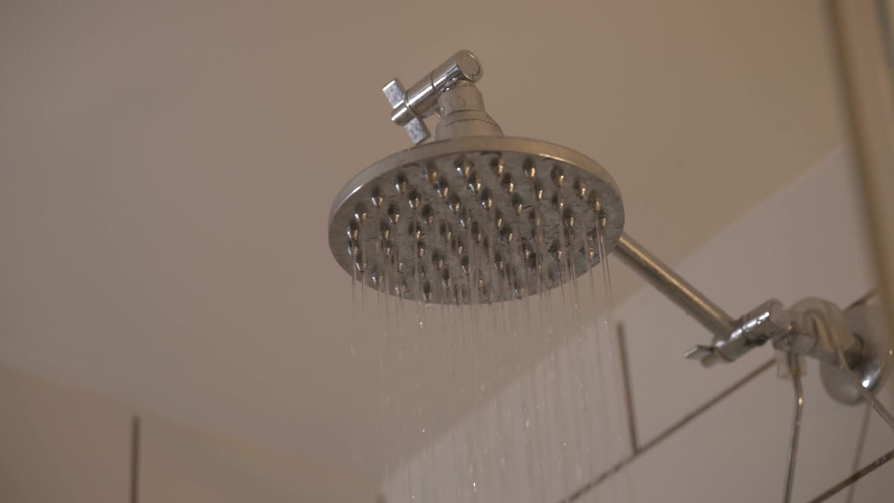 Cold Water Dripping From The Shower Head In The Bathroom. - static shot