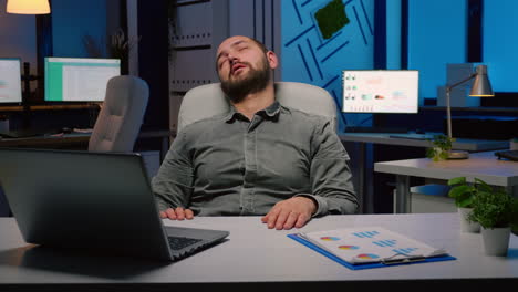 workaholic businessman slepping on chair in business company office late at night