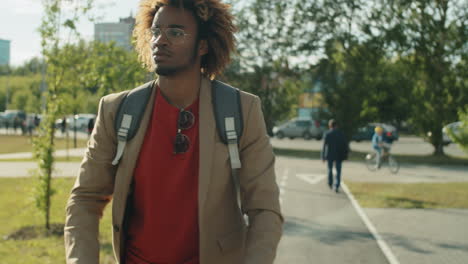 black man riding e-scooter in park