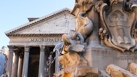 detail of the fountain of the pantheon and the pantheon in the background