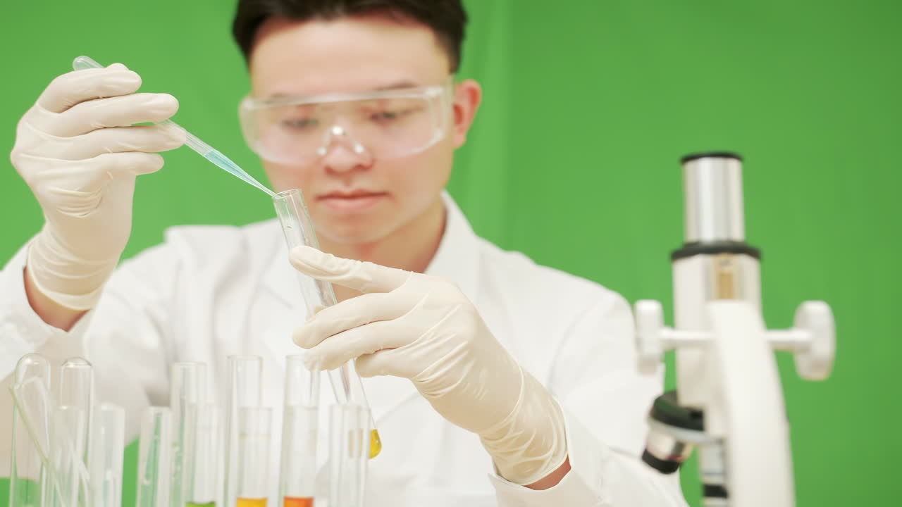 Scientist conducts experiment in laboratory with test tube and pipette