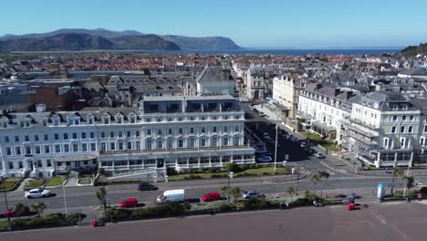 beachfront aerial view llandudno seaside coastal holiday town tourism resort hotels slow right dolly