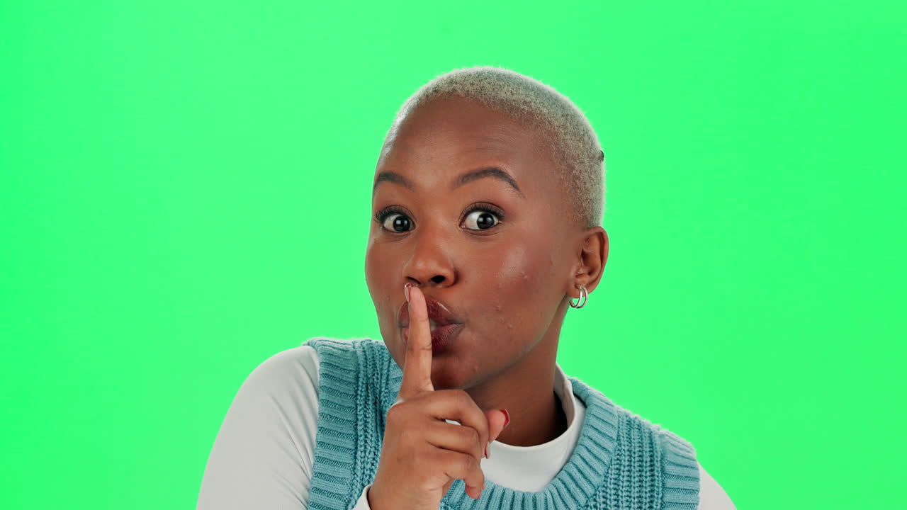 Woman gesturing silence on green screen