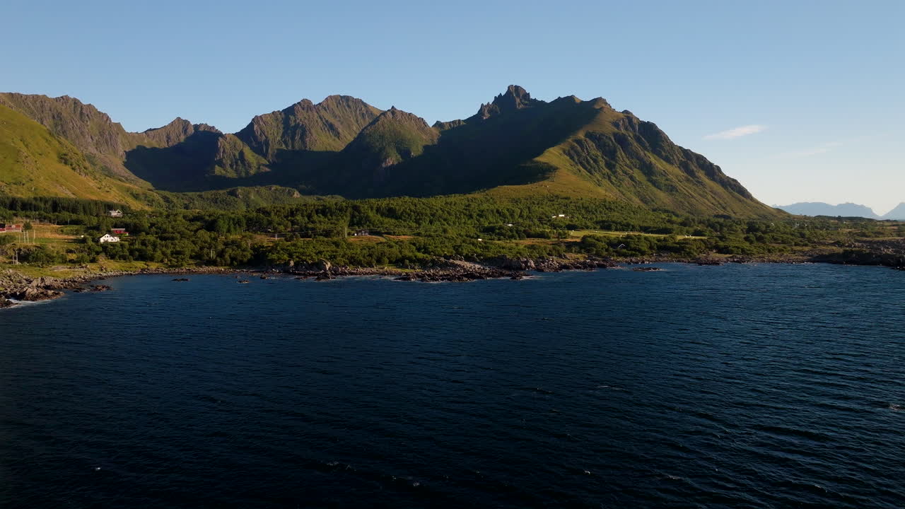Uværshula coastal landscape with mountains and sea on sunny day, Stokmarknes, Norway. Aerial backward, copy space