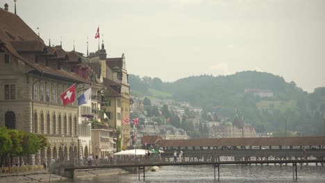 Ayuntamiento-De-Lucerna-Y-Rathaussteg-Con-Puente-De-La-Capilla-O-Kapellbrucke-En-El-Fondo,-Suiza