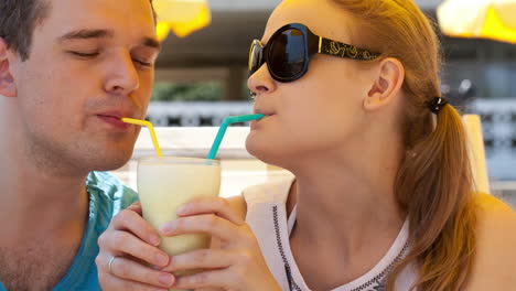 romantic couple sharing a cocktail