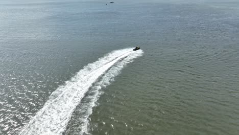 an aerial view over gravesend bay in brooklyn, ny as a jet skier enjoys the beautiful day