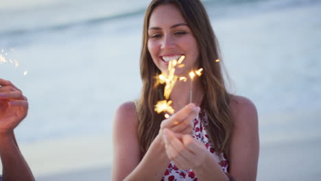 Beach,-sparklers-and-happy-couple-in-celebration