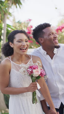 vertical video of happy married african american couple with flowers