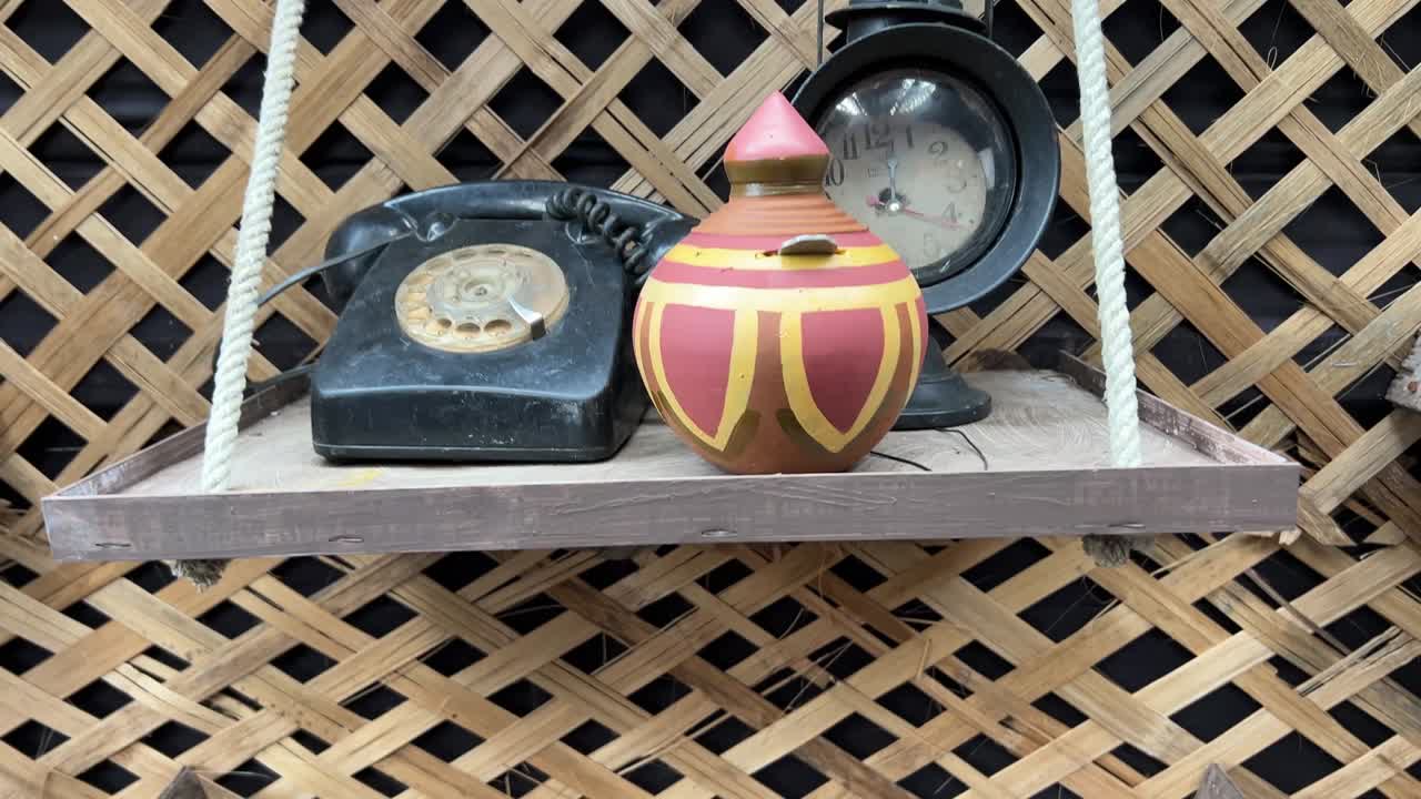 An old telephone, clock and terracota lakshmi bhandar used by Zamindar in Bengal.
