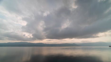 serene lake with cloudy sky and mountain reflections