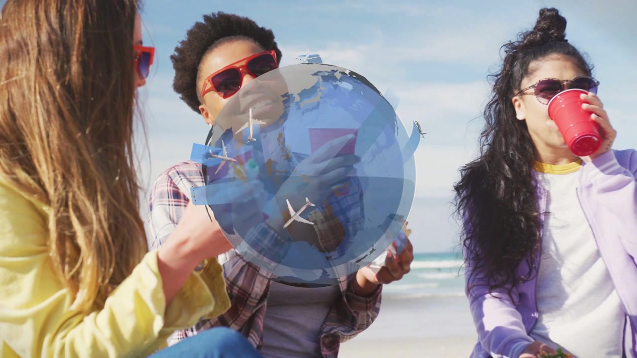 Tres mujeres sentadas en la playa con vasos rojos, comiendo bocadillos mientras un globo terráqueo de viaje aparece, ocultando y luego desapareciendo.