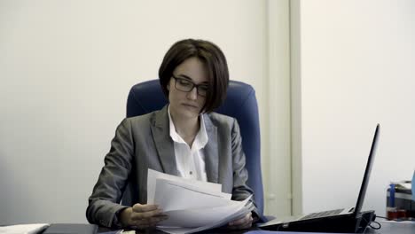 woman reading and reacting to documents