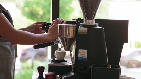 Close-up-shot-of-woman-making-coffee-in-restaurant-from-a-professional-coffee-maker
