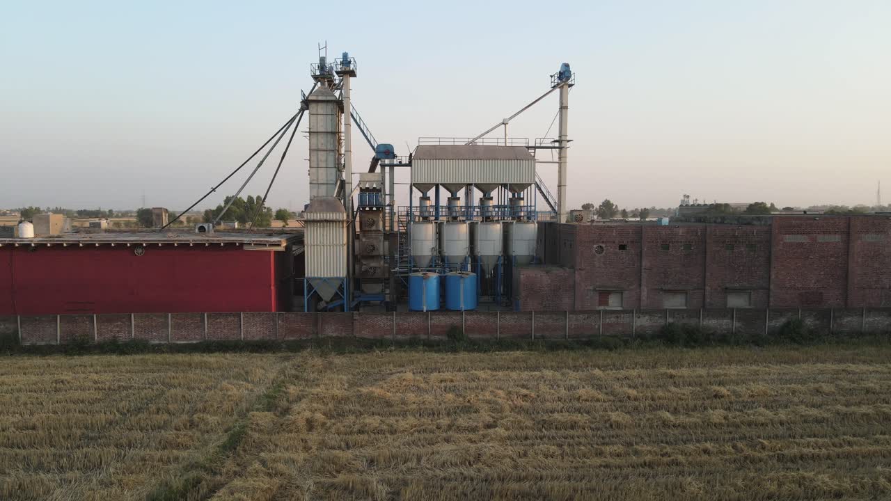 Drone view of a rice and flour mill and agricultural field in Pakistan, village life in Pakistan