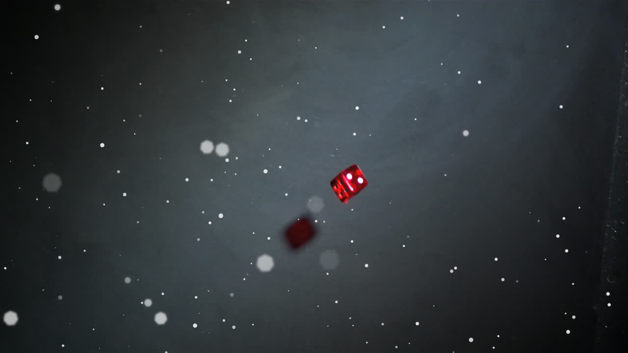 Animation af hvide prikker, der svæver over røde terninger, der falder og ruller, på sort baggrund